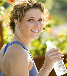 Smiling woman with bottle of water